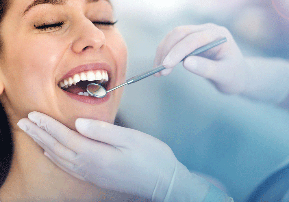 woman-smiling-and-a-dentist-looking-at-her-teeth-with-a-mirror